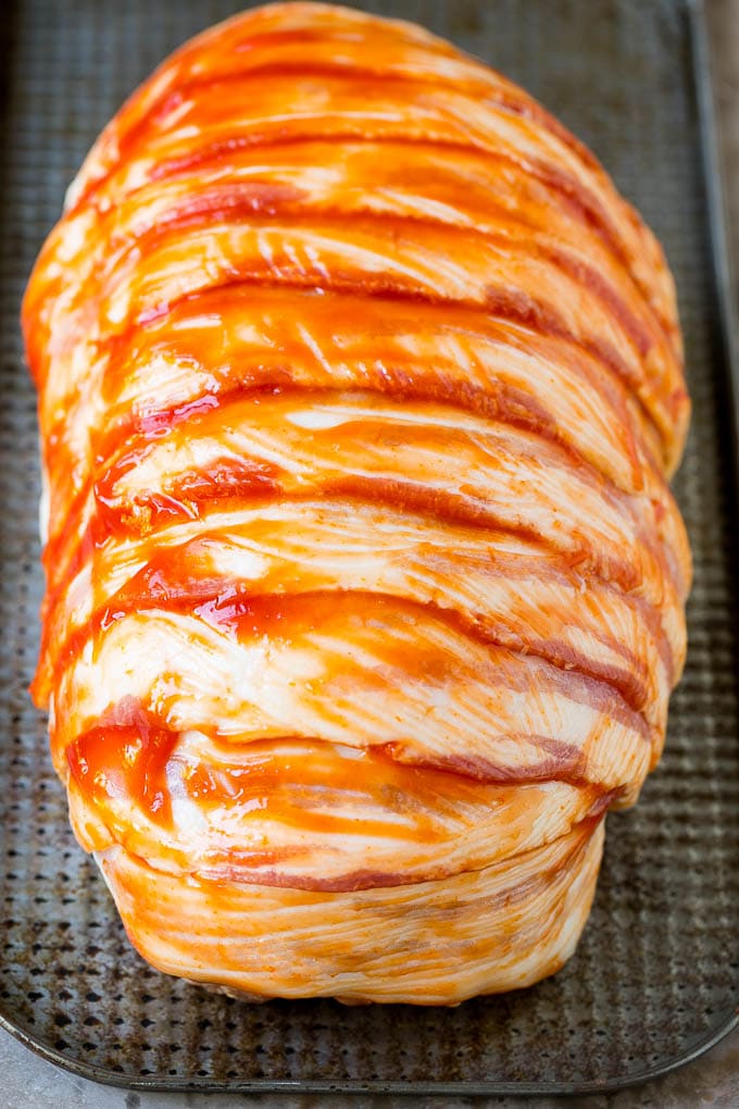 Bacon Wrapped Meatloaf Recipe | Beef Meatloaf #meatloaf #beef #groundbeef #bacon #dinner #jonep Raw slices of bacon wrapped around a seasoned ground beef loaf.