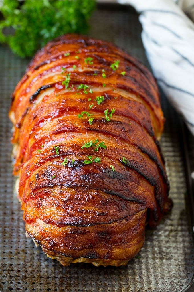 Bacon Wrapped Meatloaf Recipe | Beef Meatloaf #meatloaf #beef #groundbeef #bacon #dinner #jonep Meatloaf wrapped in slices of bacon and baked, then topped with parsley.