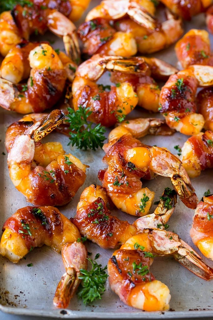 Bacon Wrapped Shrimp Recipe | Bacon Shrimp #shrimp #bacon #appetizer #dinner #jonep #seafood Bacon wrapped shrimp in a sweet and savory glaze, garnished with parsley.