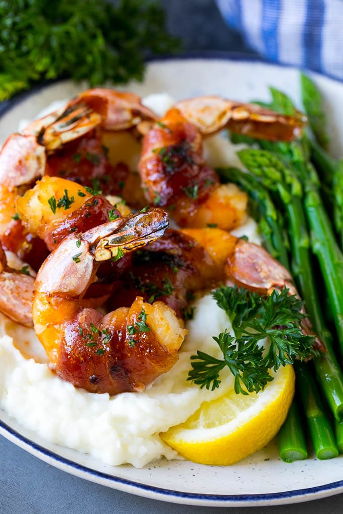 Bacon Wrapped Shrimp Recipe | Bacon Shrimp #shrimp #bacon #appetizer #dinner #jonep #seafood Bacon wrapped shrimp served over mashed potatoes with green beans.