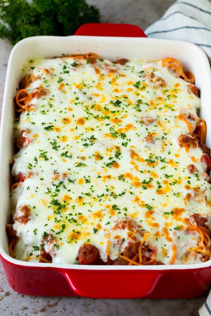 Baked Spaghetti Recipe | Baked Pasta #spaghetti #pasta #cheese #casserole #beef #sausage #dinner #jonep Spaghetti in a baking dish with melted cheese baked on top.
