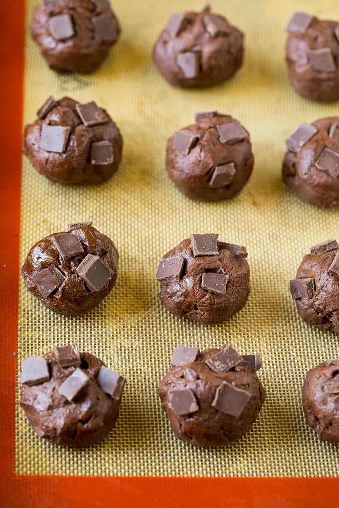 Brownie Cookies Recipe | Chocolate Cookies #cookies #brownies #chocolate #dessert #baking #jonep Balls of cookie dough with chocolate pieces pressed into the tops.