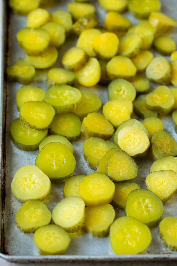 Fried Pickles Recipe #pickles #appetizer #snack #jonep Sliced dills on a sheet pan.