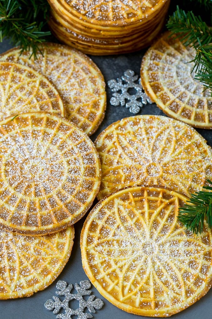 Pizzelle Cookies Recipe #cookies #baking #dessert #christmas #jonep Pizzelle cookies cooked to golden brown and coated in powdered sugar.