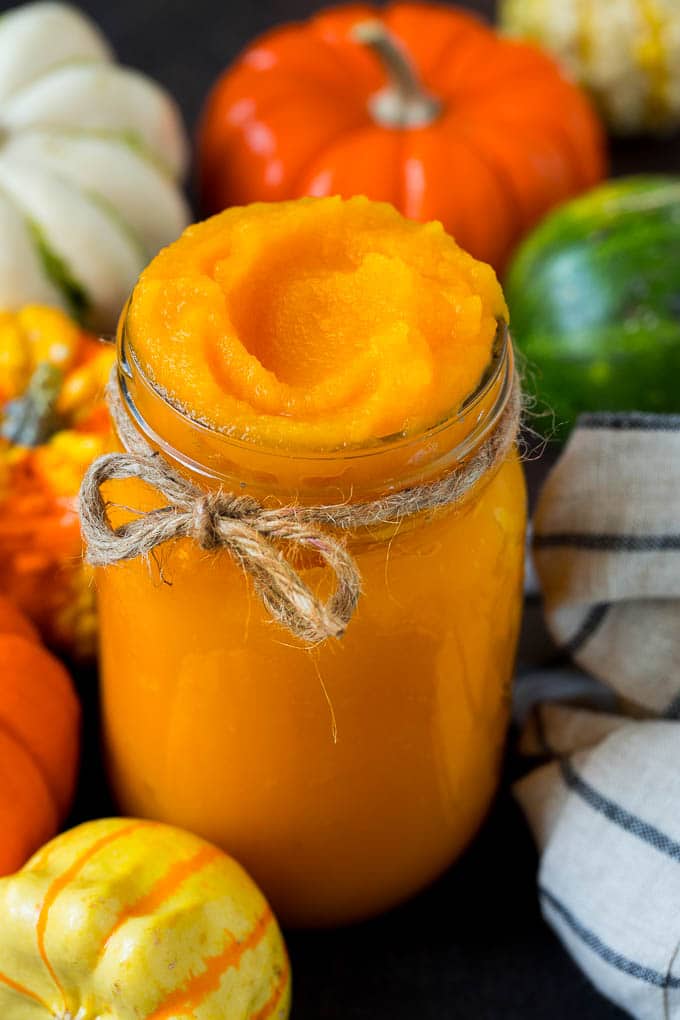 Pumpkin Puree Recipe #pumpkin #baking #fall #thanksgiving #jonep A jar of pumpkin puree surrounded by fall produce.