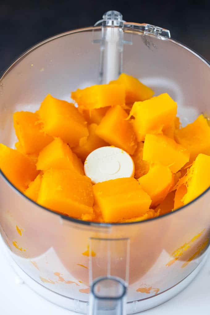 Pumpkin Puree Recipe #pumpkin #baking #fall #thanksgiving #jonep Cubes of pumpkin in a food processor.