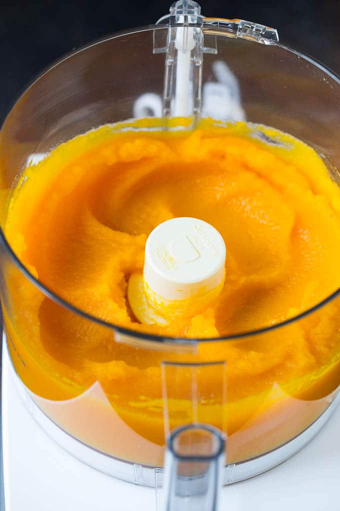 Pumpkin Puree Recipe #pumpkin #baking #fall #thanksgiving #jonep Pureed pumpkin in a food processor.