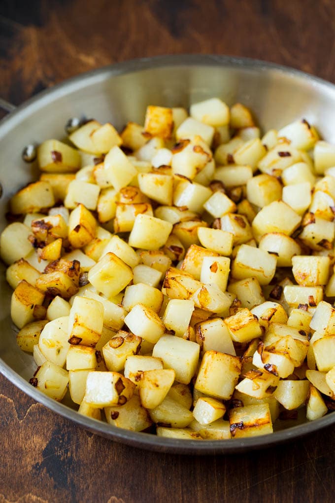 Corned Beef Hash Recipe #hash #cornedbeef #stpatricksday #breakfast #brunch #potatoes #jonep Sauteed potatoes in a skillet.