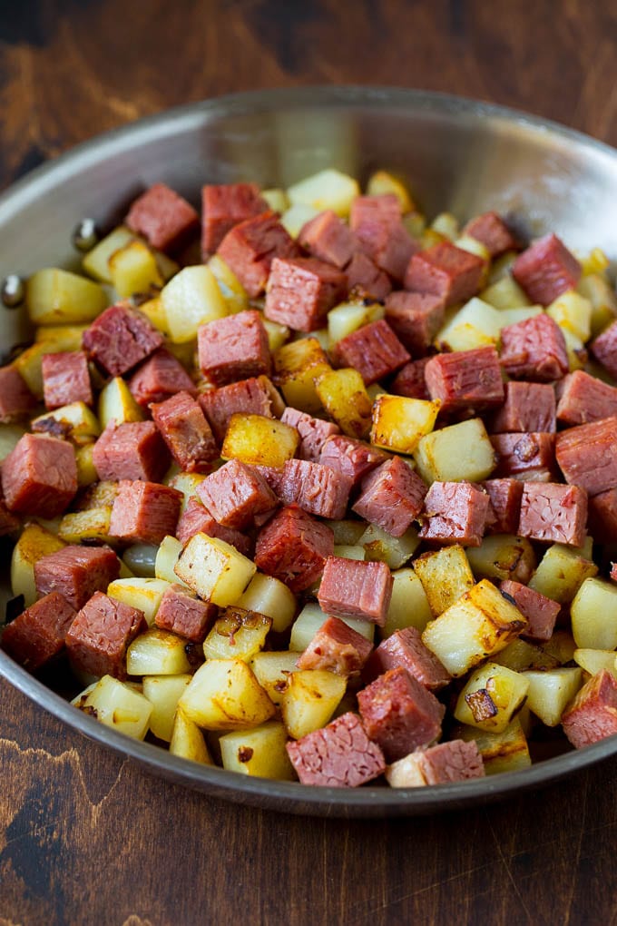 Corned Beef Hash Recipe #hash #cornedbeef #stpatricksday #breakfast #brunch #potatoes #jonep Corned beef and potatoes cooked together in a pan.