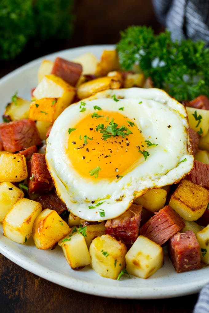 Corned Beef Hash Recipe #hash #cornedbeef #stpatricksday #breakfast #brunch #potatoes #jonep A plate of corned beef hash topped with a fried egg.
