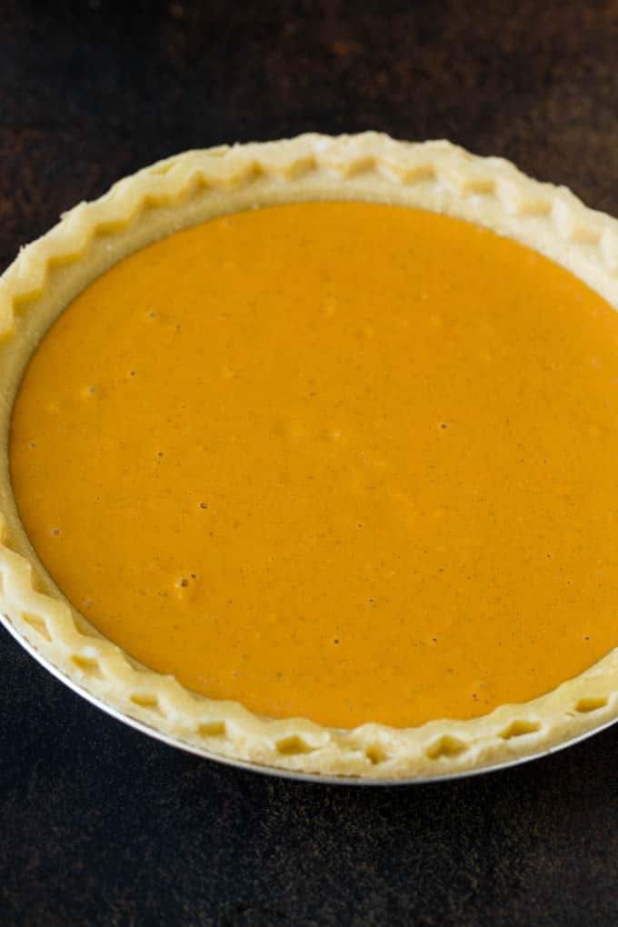 Homemade Pumpkin Pie Recipe | Pumpkin Pie #pie #pumpkin #baking #thanksgiving #fall #dessert #jonep Pie filling inside a pie crust.