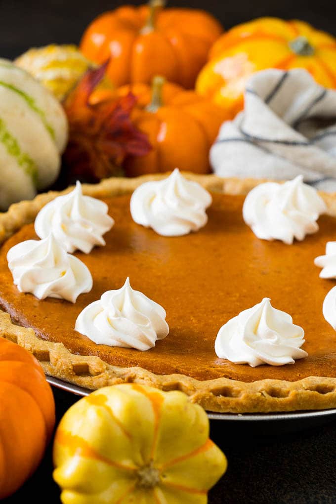 Homemade Pumpkin Pie Recipe | Pumpkin Pie #pie #pumpkin #baking #thanksgiving #fall #dessert #jonep Homemade pumpin pie topped with rosettes of whipped cream.
