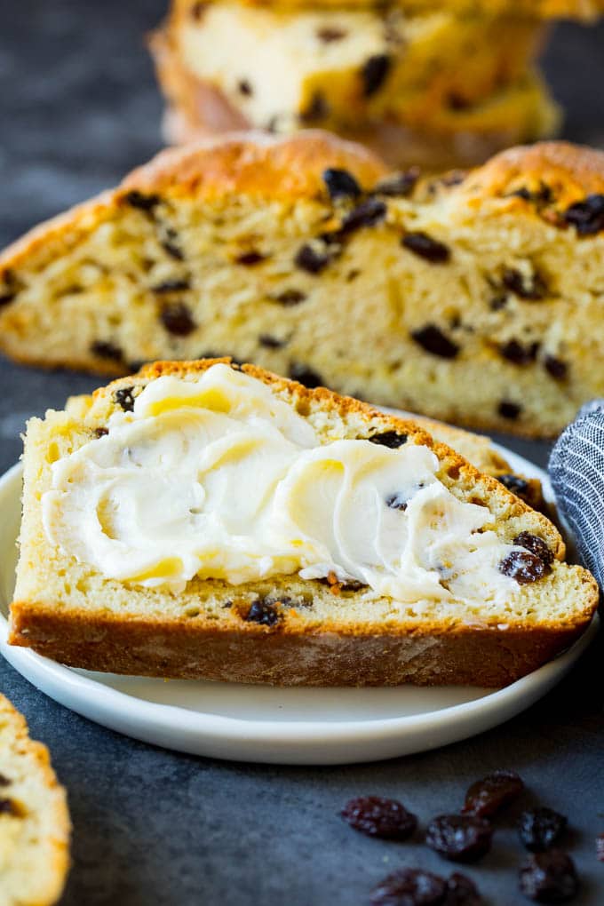 Irish Soda Bread Recipe #bread #baking #stpatricksday #sidedish #jonep A slice of Irish soda bread with butter spread on it.