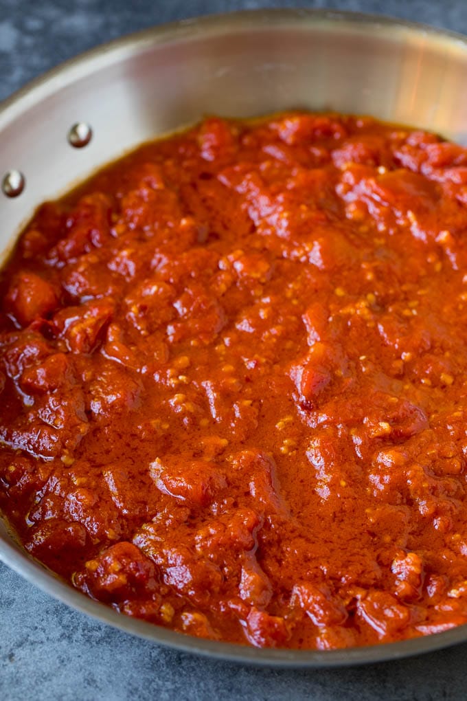 Pasta Puttanesca Recipe #pasta #tomatoes #olives #italianfood #dinner #jonep Homemade tomato sauce in a skillet.