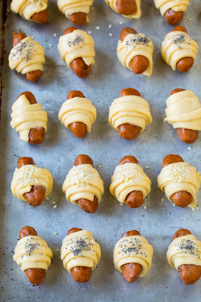 Pigs in a Blanket Recipe #hotdogs #appetizer #snack #comfortfood #jonep Mini hot dogs wrapped in crescent dough and topped with seeds.