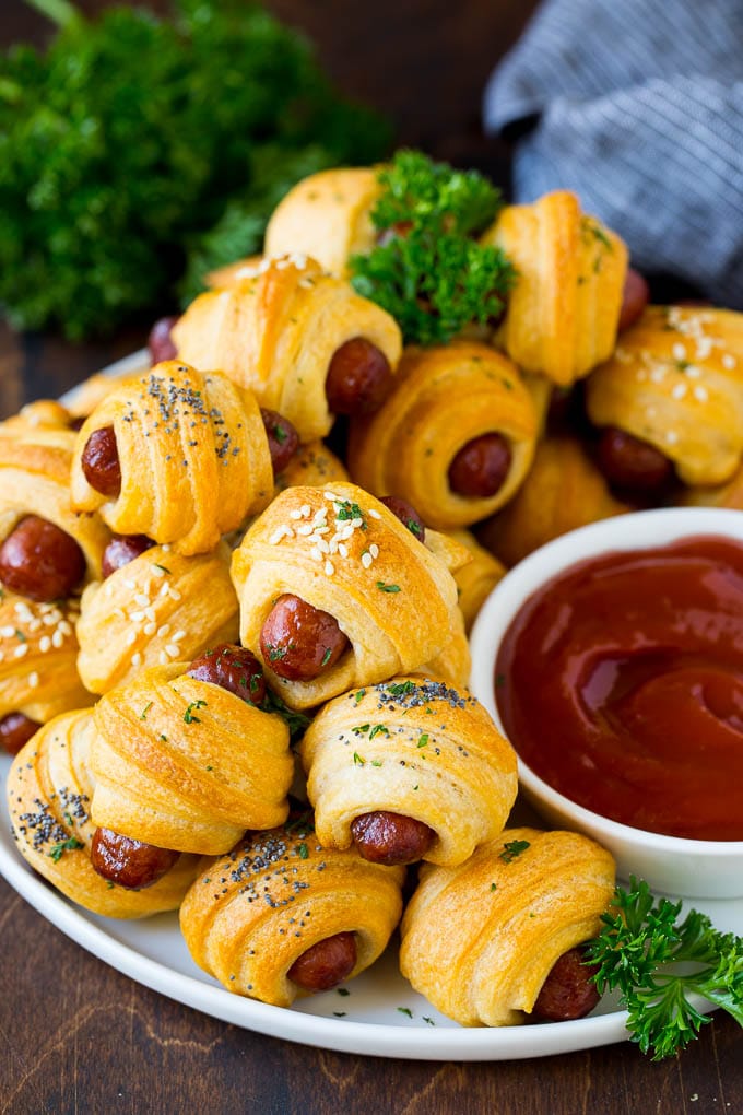Pigs in a Blanket Recipe #hotdogs #appetizer #snack #comfortfood #jonep A plate of pigs in a blanket served with ketchup.