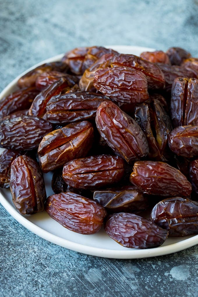 Bacon Wrapped Dates #appetizer #bacon #dates #cheese #jonep Dates split open on a plate.