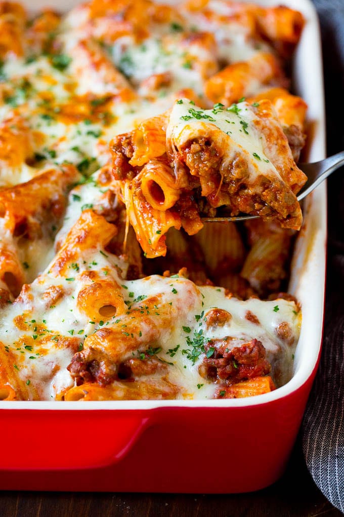 Baked Rigatoni Pasta #pasta #dinner #italianfood #groundbeef #jonep #casserole A spoon serving up a portion of baked rigatoni pasta.