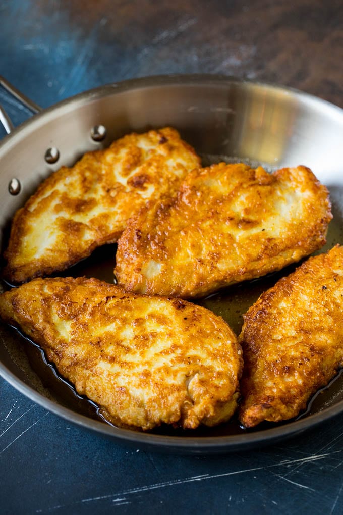 Chicken Francese Recipe #chicken #lemon #dinner #jonep Battered and pan fried chicken cutlets in a pan.