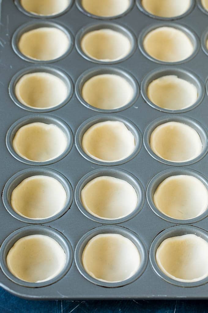 Mini Quiche Recipe #eggs #breakfast #brunch #appetizer #jonep Pie crust rounds pressed into muffin tins.