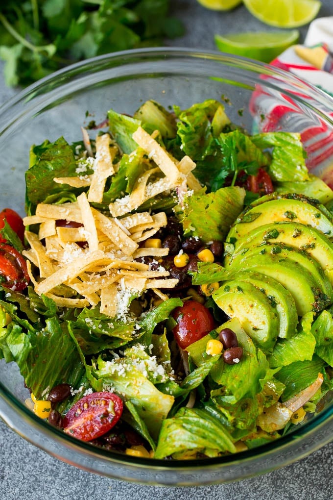 Mexican Salad Recipe #salad #corn #beans #avocado #tomatoes #jonep Mexican salad with lettuce, corn, beans and tomato, tossed in a lime dressing.