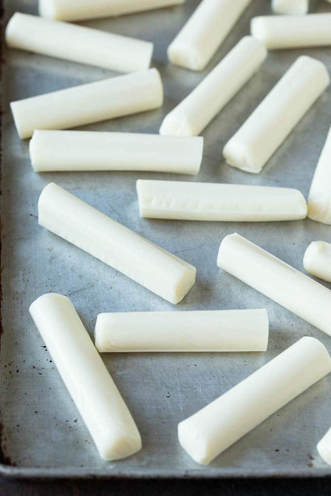 Mozzarella Sticks Recipe #cheese #appetizer #jonep Cheese sticks on a sheet pan.