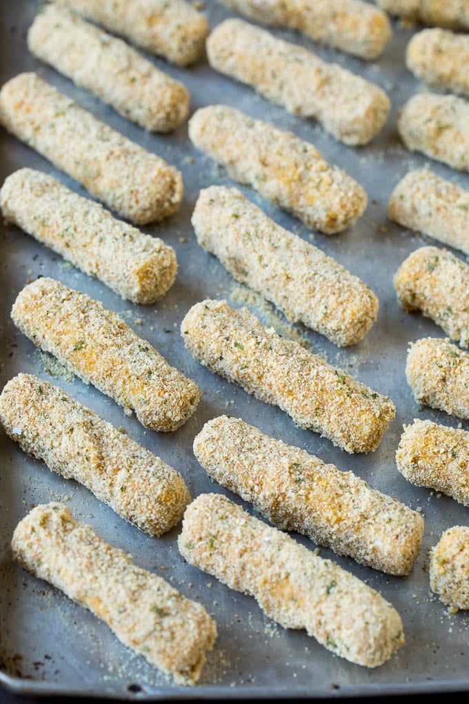 Mozzarella Sticks Recipe #cheese #appetizer #jonep Breaded cheese on a baking pan.