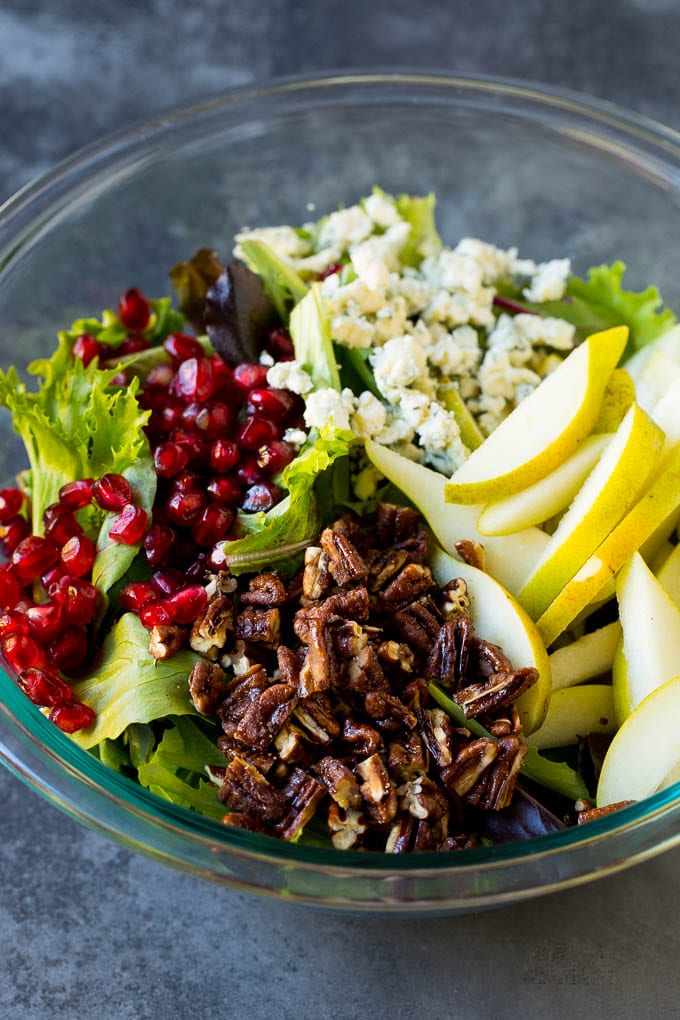 Pear Salad Recipe #salad #pears #fall #winter #dinner #jonep Lettuce with sliced pears, blue cheese and pecans on top.