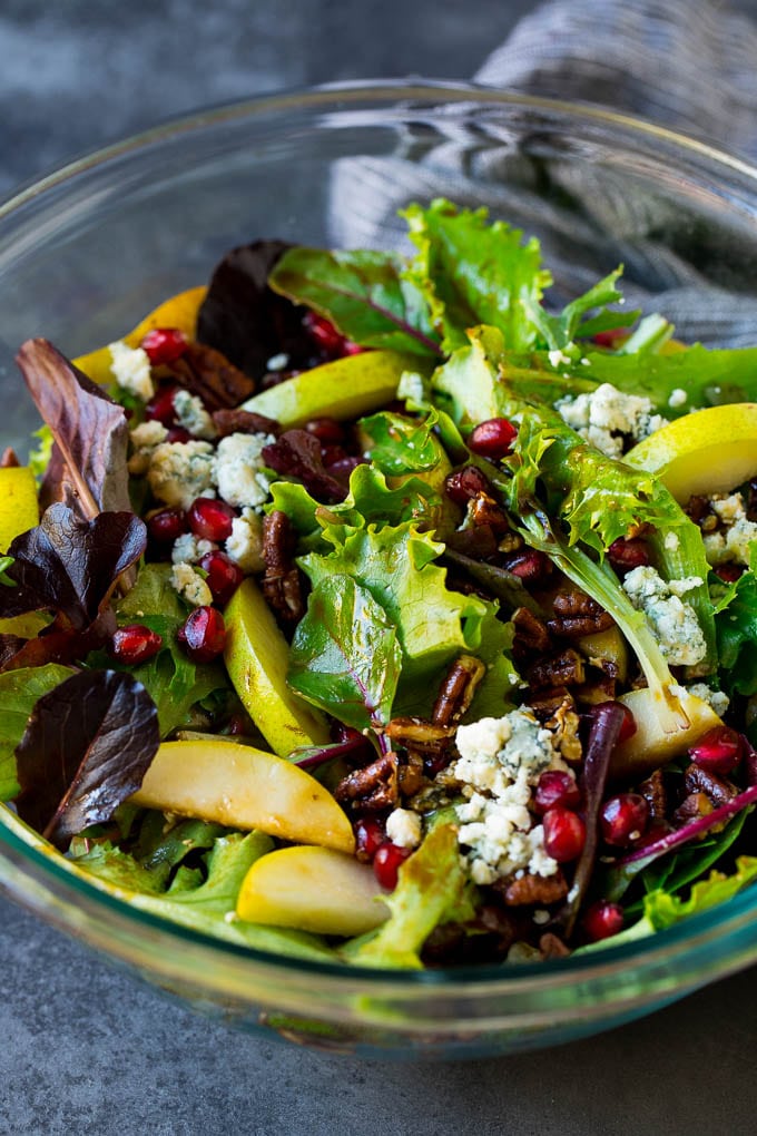 Pear Salad Recipe #salad #pears #fall #winter #dinner #jonep A bowl of pear salad with pomegranate, blue cheese and candied pecans.