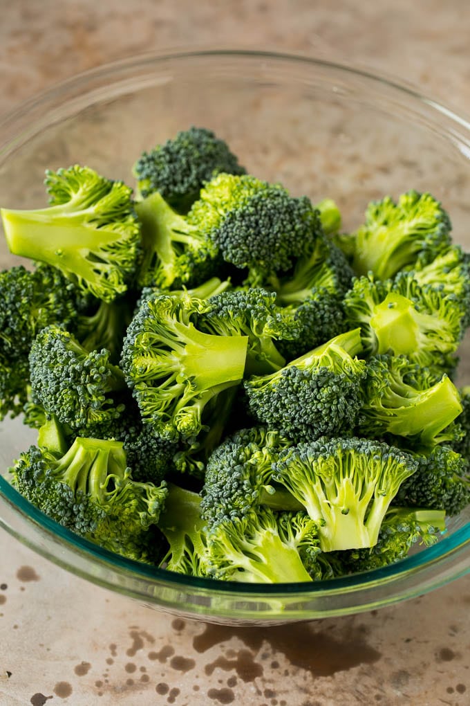 Grilled broccoli is packed with flavor and is a colorful and healthy side dish! #broccoli #jonep Green florets in a bowl.