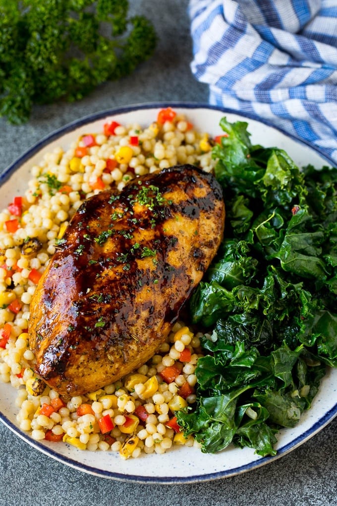 Sauteed kale flavored with olive oil and garlic, a quick and easy side dish! #kale #jonep Grilled chicken served with a side of sauteed kale.