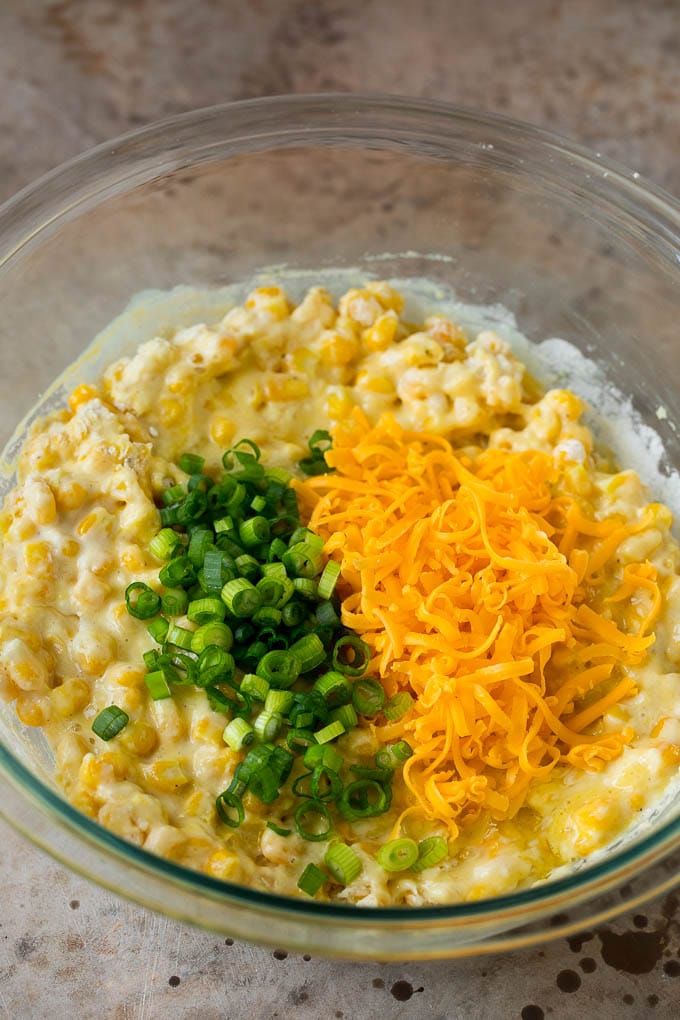 These crispy corn fritters are easy to make and are the perfect appetizer or lighter main course. #corn #jonep Corn batter topped with green onions and shredded cheese.