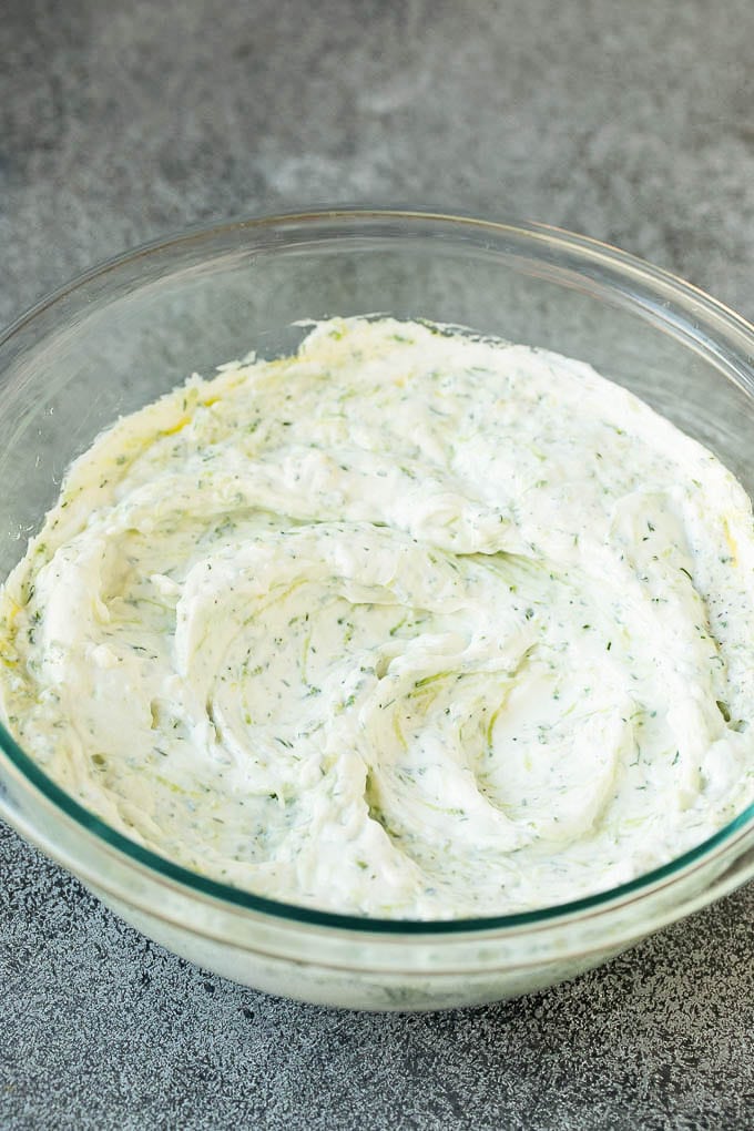 The best homemade tzatziki sauce with cucumber and herbs mixed into Greek yogurt. #appetizer #jonep Tzatziki sauce in a glass bowl.