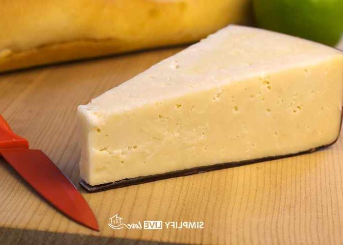 SONY DSC asiago cheese on wooden counter with red knife