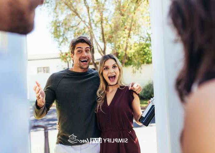 man and woman surprising a friend at the door by visiting last minute