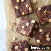 Nutella Hazelnut Brownies 6 Nutella brownies with hazelnuts on a plate