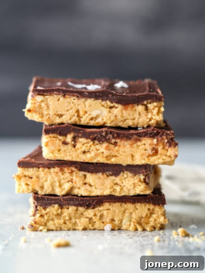 Ultimate Chocolate Peanut Butter No Bake Bars 6 Stack of no-bake chocolate peanut butter bars, showing off the distinct layers.