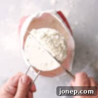 Mastering Accurate Flour Measurement 8 A measuring cup filled with flour for baking