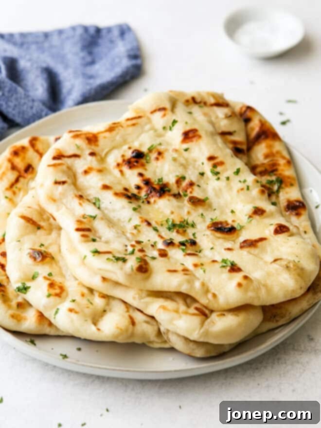 Fire-Kissed Flatbread 2 grilled flatbread stacked on a plate