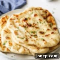 Fire-Kissed Flatbread 10 grilled flatbread stacked on a plate