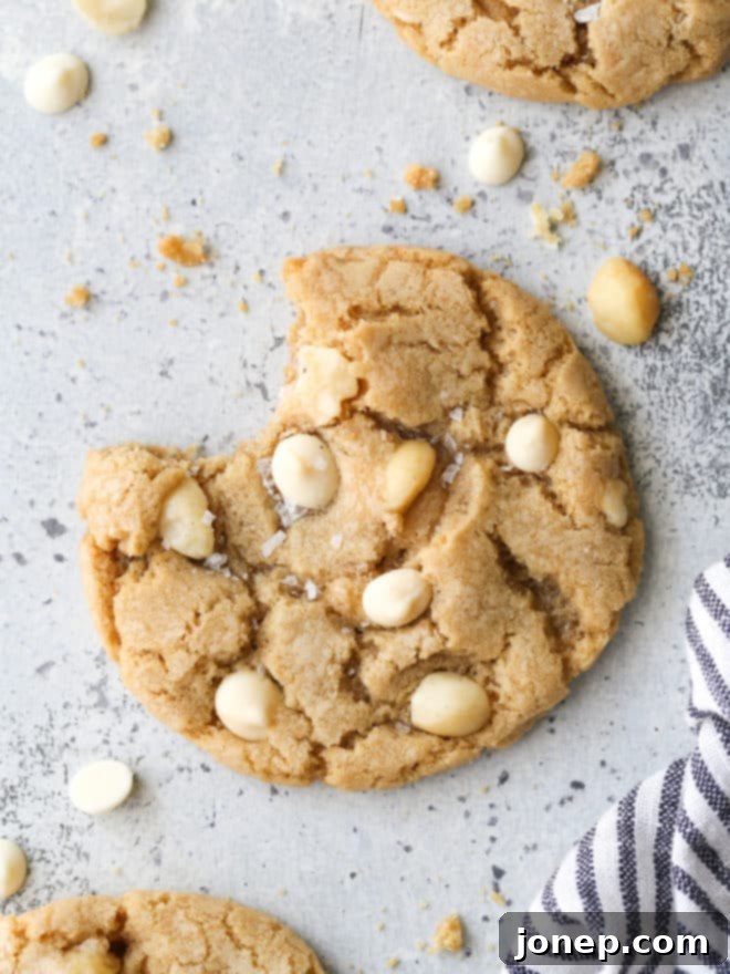 a white chocolate macadamia nut cookie with bite taken out