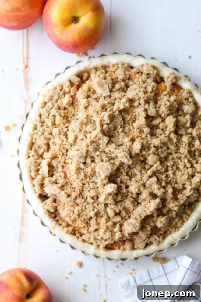 A freshly baked peach crumb tart cooling on a wire rack, filling the kitchen with a sweet aroma.