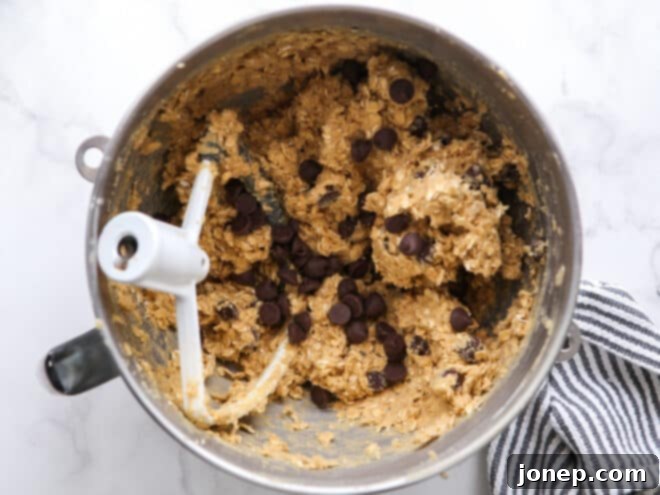 chocolate chip oatmeal cookie dough in mixer bowl