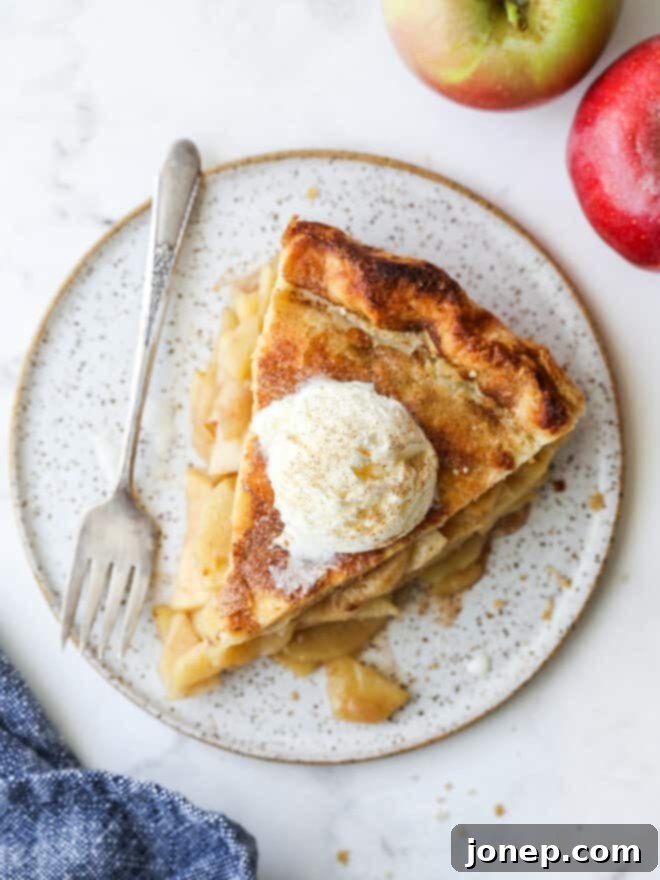 A beautifully baked deep-dish apple pie, golden brown and ready to be sliced.