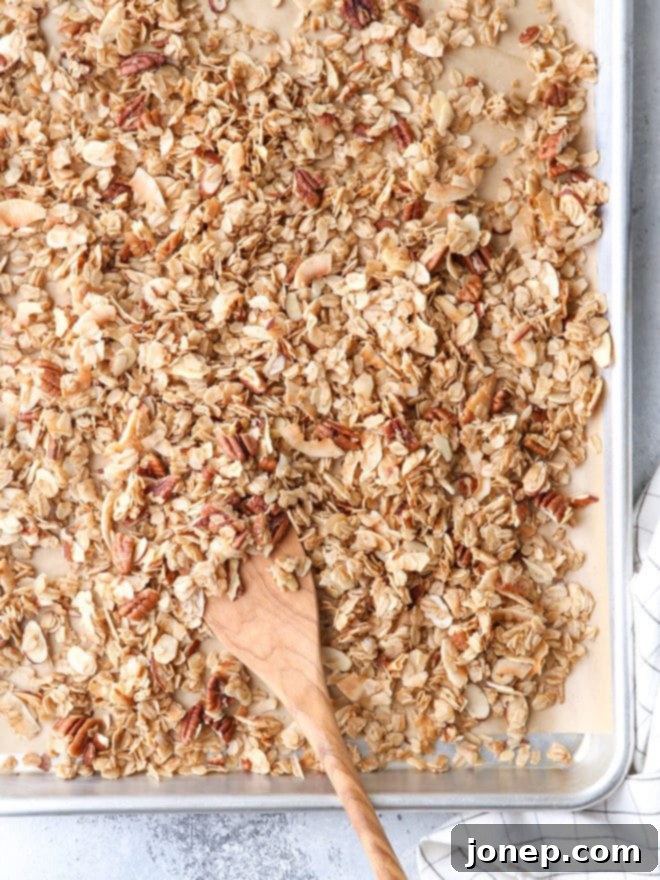 A close-up shot of freshly baked homemade granola, showcasing its golden-brown color and crunchy clusters.
