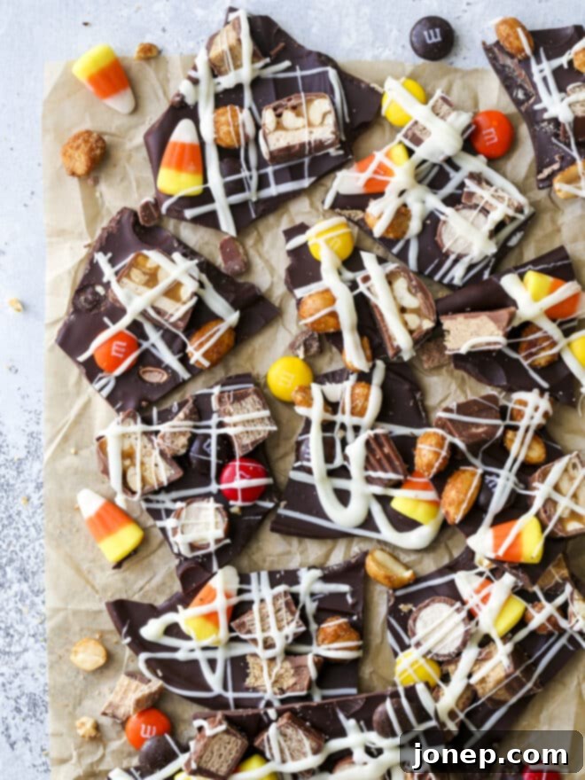 Halloween Candy Bark 2 Irregularly broken pieces of colorful Halloween candy bark on a white surface
