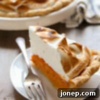 Caramelized Marshmallow Meringue Sweet Potato Pie 9 slice of sweet potato pie on a plate, featuring its golden toasted meringue
