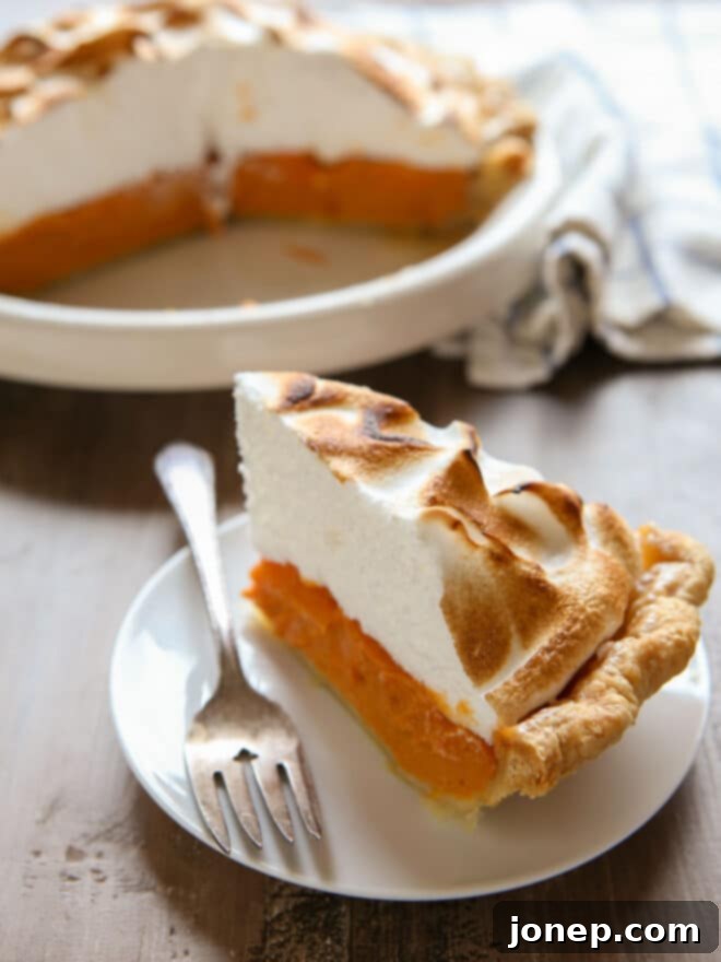 Caramelized Marshmallow Meringue Sweet Potato Pie 8 slice of sweet potato pie on a plate, with a fork ready to enjoy