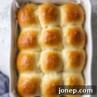soft white dinner rolls in the baking pan