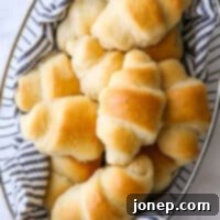 Effortless Cloud Crescents 10 closeup of easy no-knead fairy crescent rolls in a bread basket